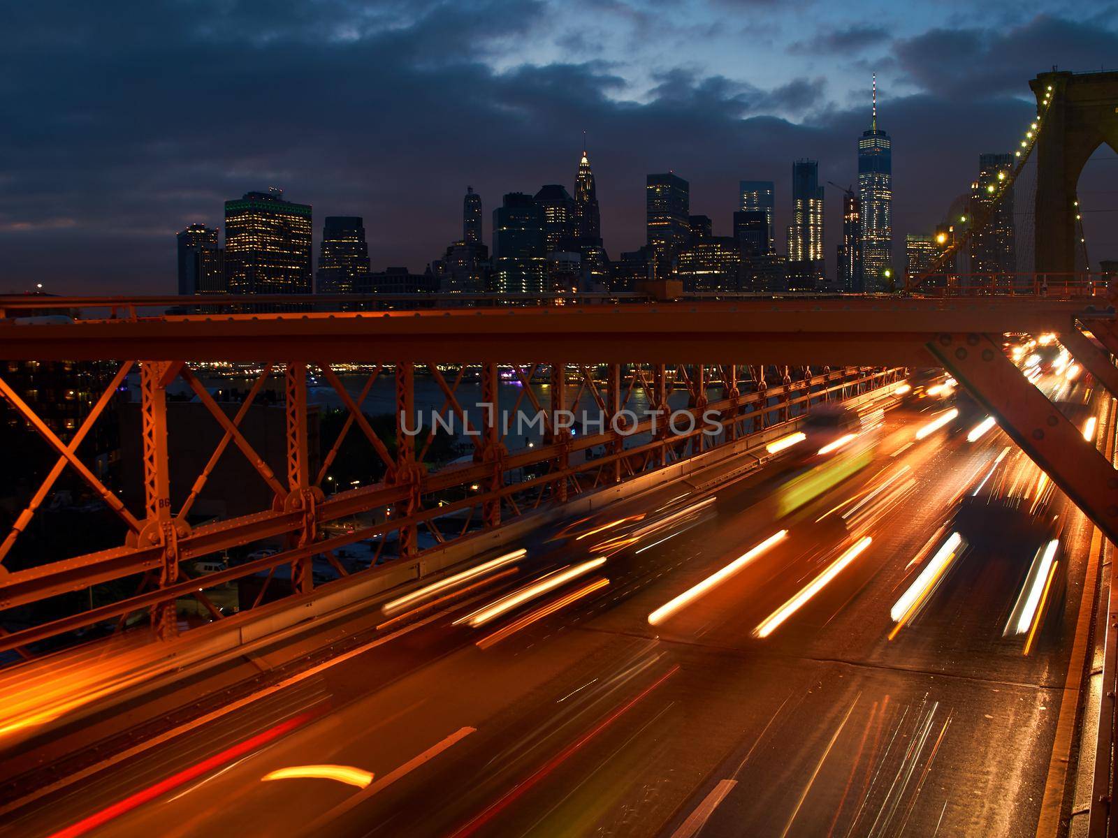 Long exposure shot of cars leaving Manhattan via Brooklyn Bridge in New York, USA