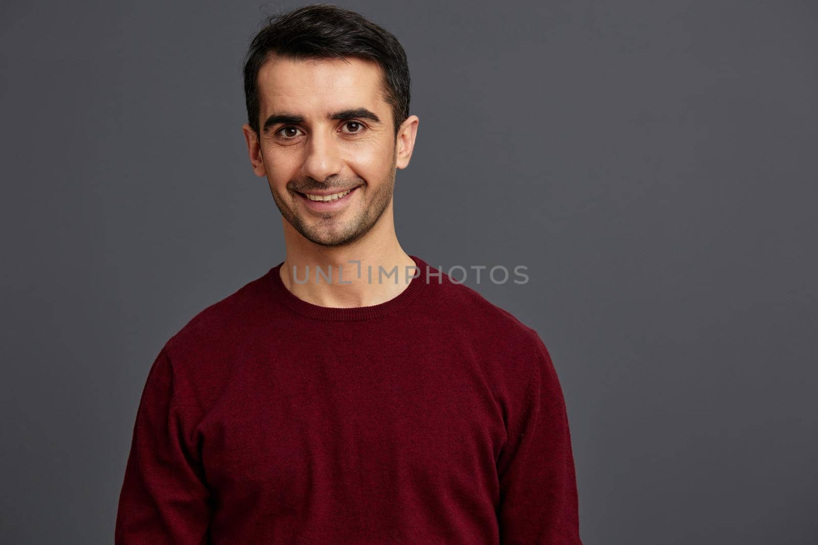 handsome man in a red sweater hand gesture posing self confidence cropped view by SHOTPRIME