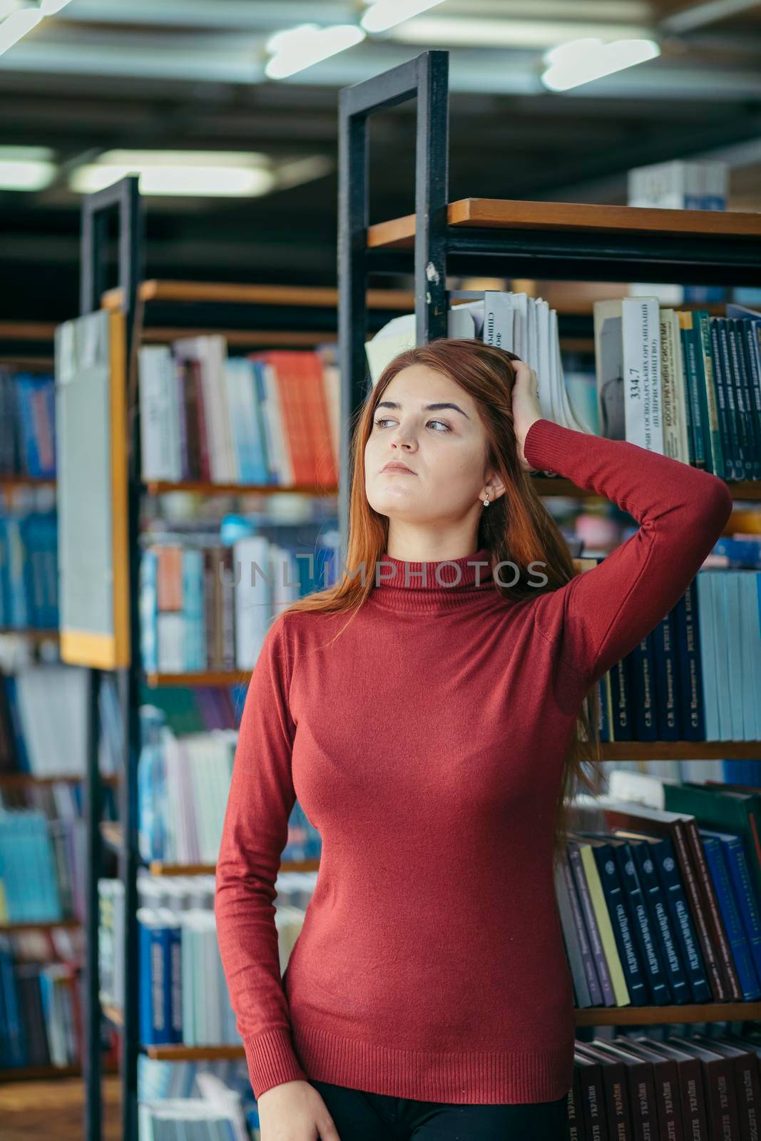 A girl holding a book shelf, student in the library by Dmytro125