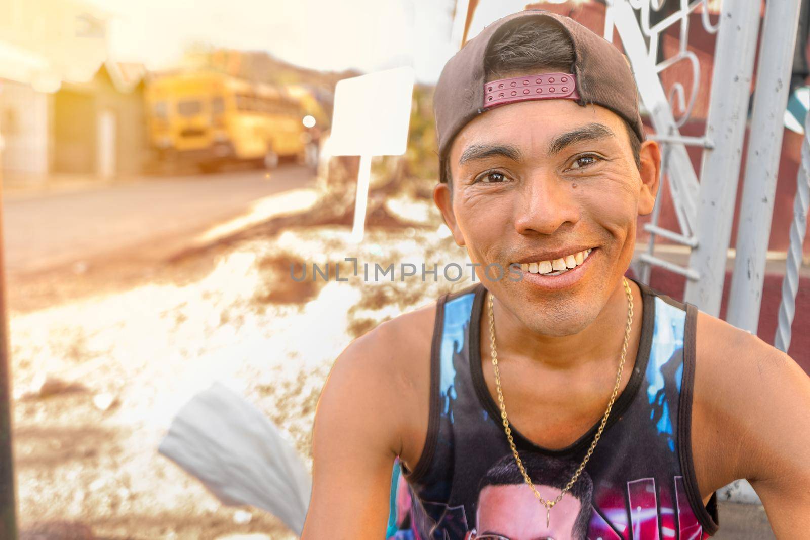 Portrait of a latino young man from Nicaragua smiling at camera. The man is sitting waiting for the departure of the transport that will take him to his city.