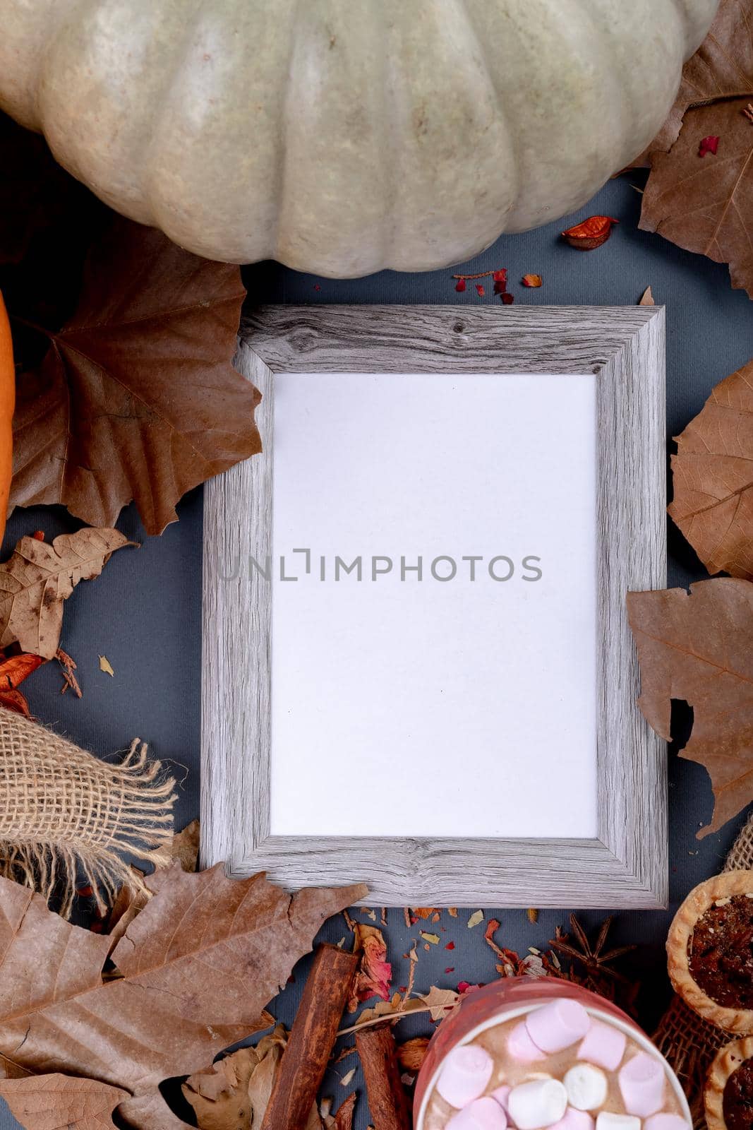 Composition of halloween decoration with pumpkin and frame with copy space on grey background. halloween tradition and celebration concept digitally generated image.