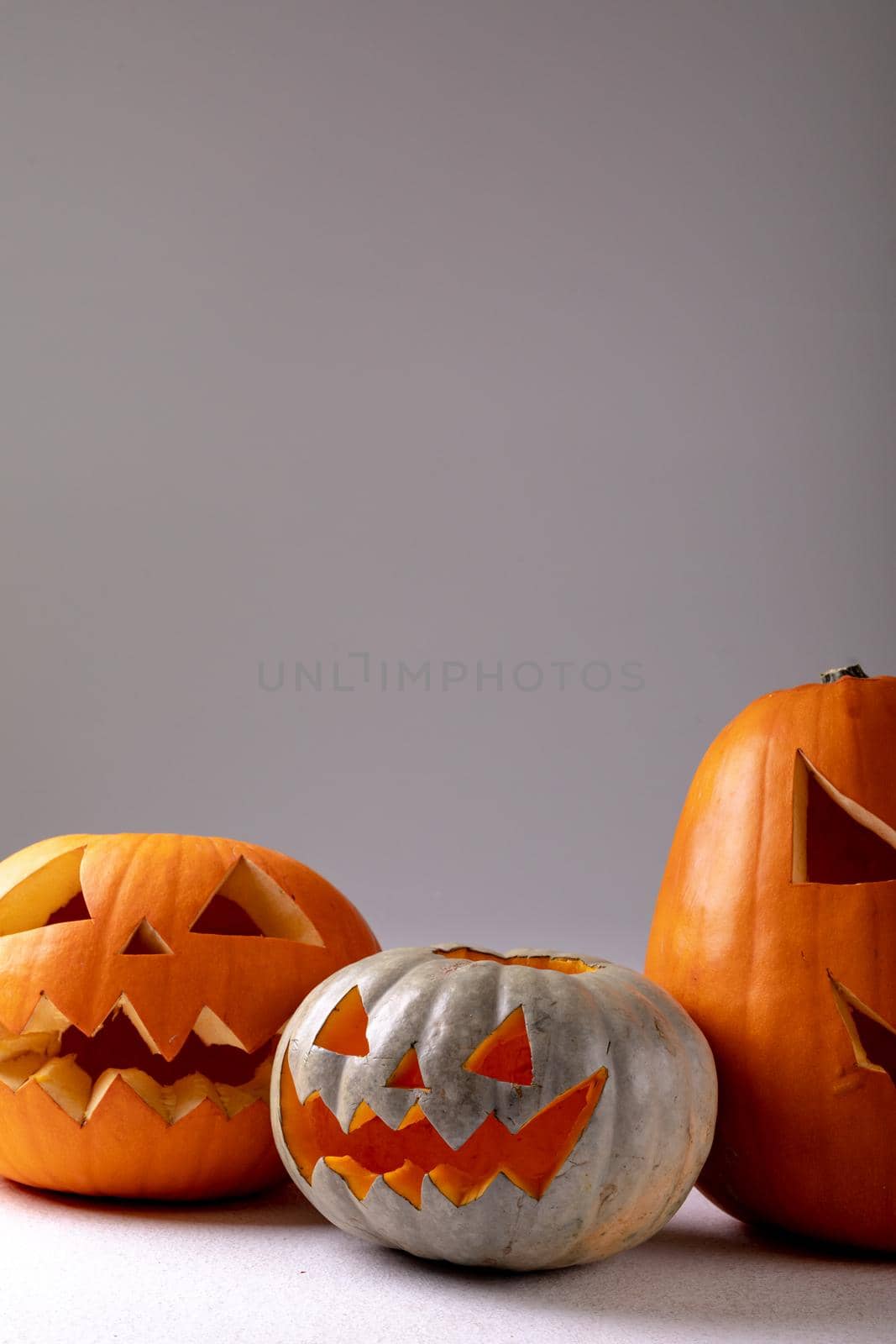 Composition of halloween jack o lanterns and copy space on grey background by Wavebreakmedia