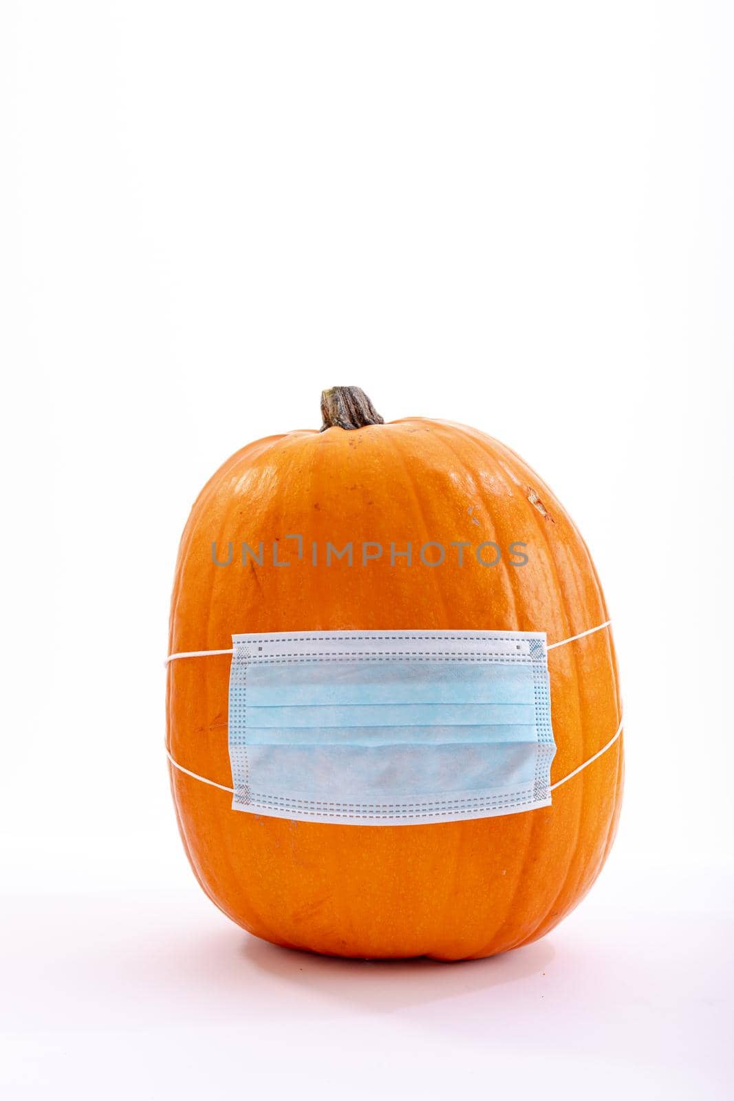 Halloween pumpkin with face mask on white background by Wavebreakmedia