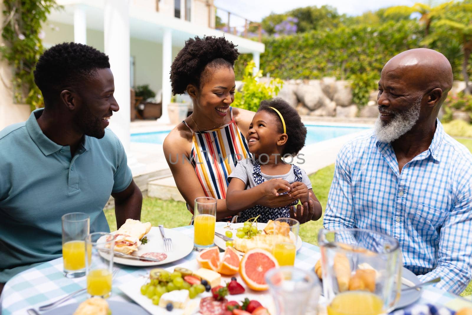 African american family spending leisure time together at backyard during brunch. family, love and togetherness concept, unaltered.
