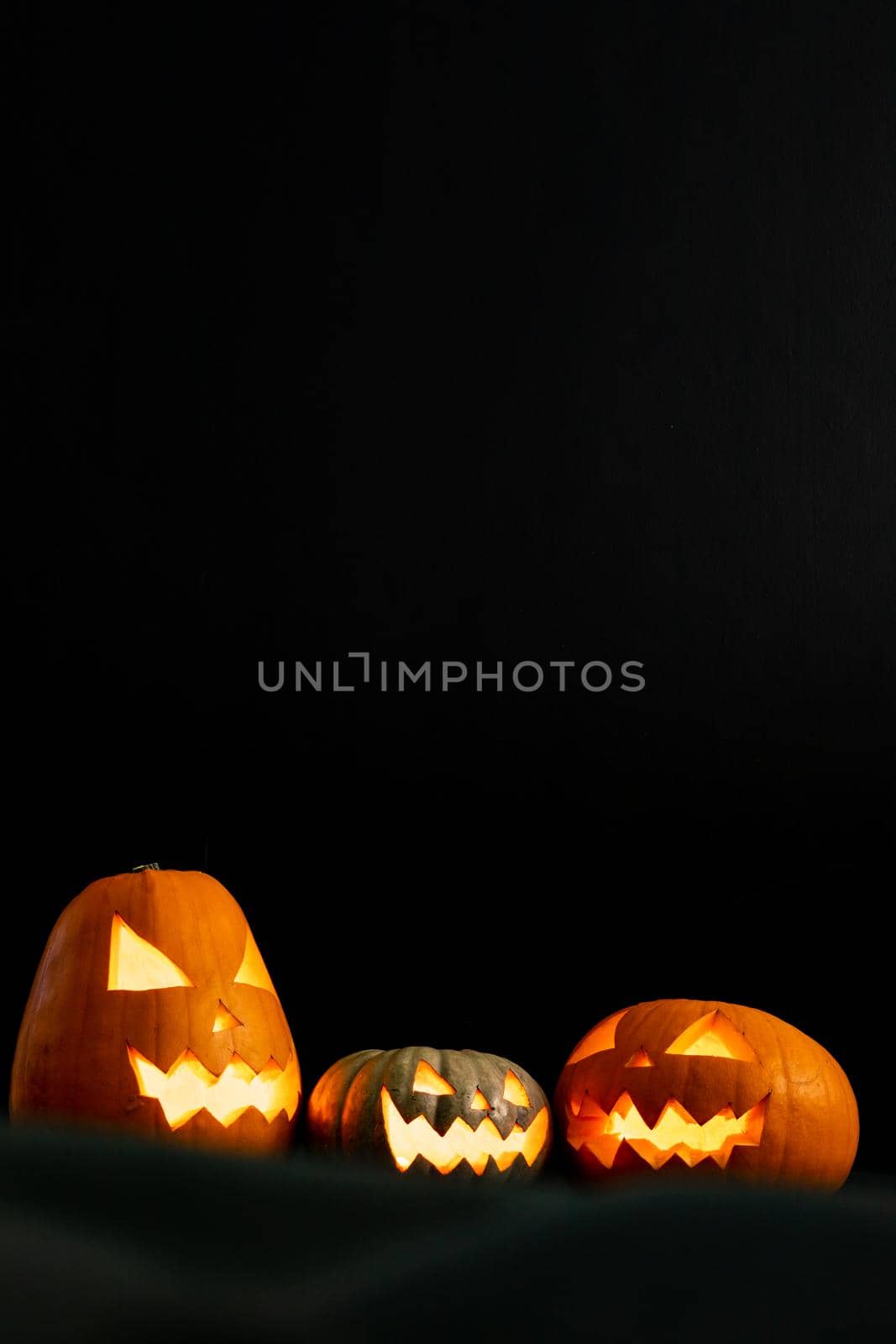 Composition of halloween jack o lanterns and copy space on black background. horror, fright, halloween tradition and celebration concept digitally generated image.