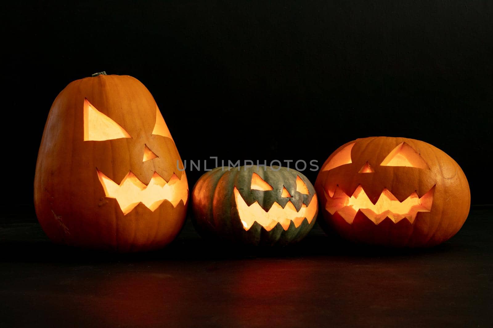 Composition of halloween jack o lanterns and copy space on black background. horror, fright, halloween tradition and celebration concept digitally generated image.