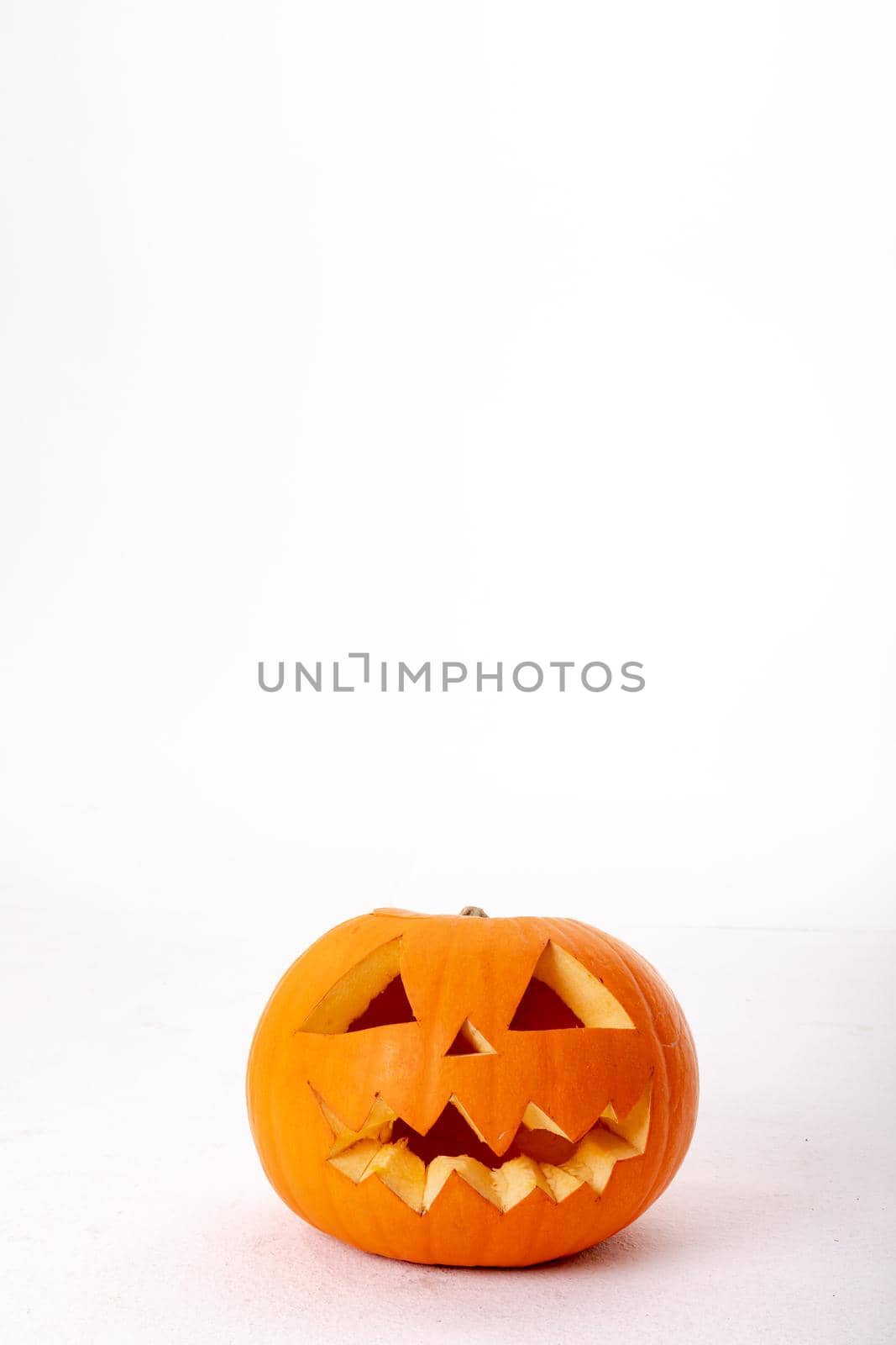 Composition of halloween jack o lantern and copy space on white background. horror, fright, halloween tradition and celebration concept digitally generated image.