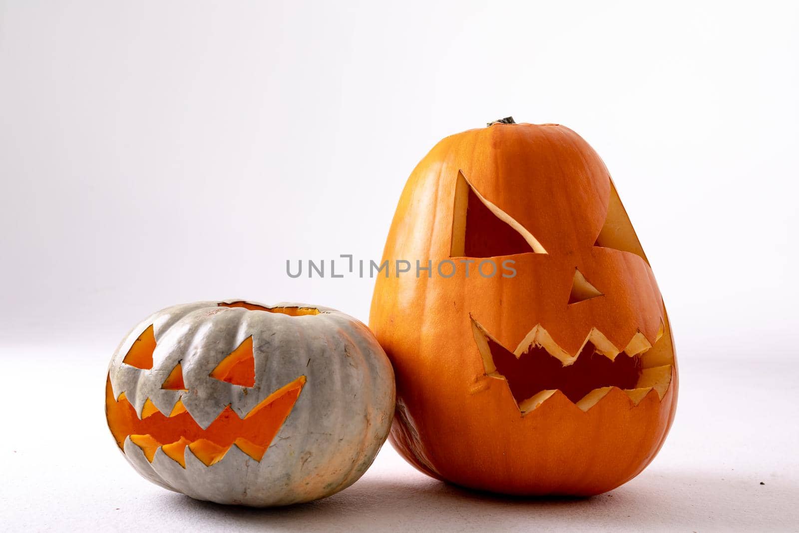 Composition of halloween jack o lanterns and copy space on white background. horror, fright, halloween tradition and celebration concept digitally generated image.