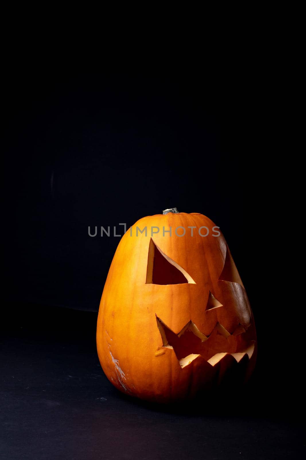Composition of halloween jack o lantern and copy space on black background. horror, fright, halloween tradition and celebration concept digitally generated image.