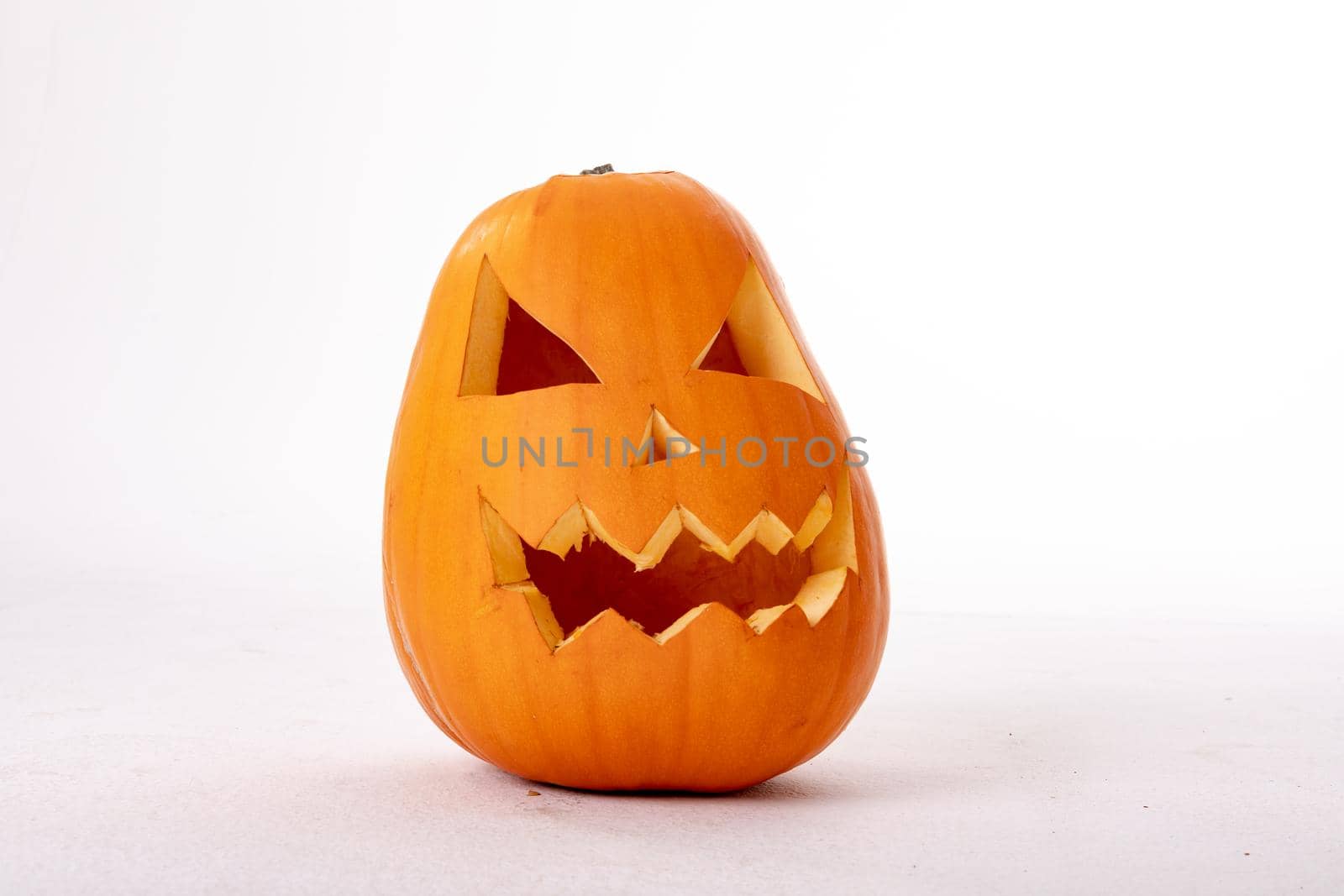 Composition of halloween jack o lantern and copy space on white background. horror, fright, halloween tradition and celebration concept digitally generated image.