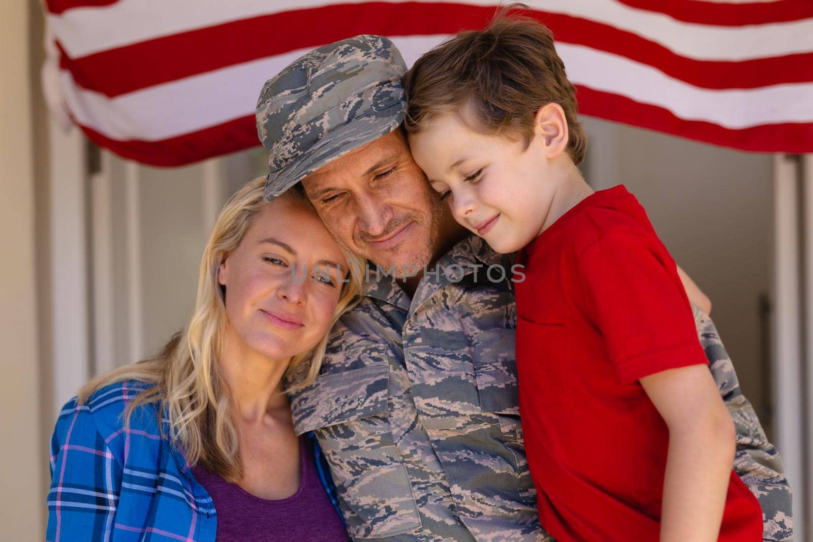 Caucasian family with military man standing entrance of house. family, love and patriotism concept, unaltered.