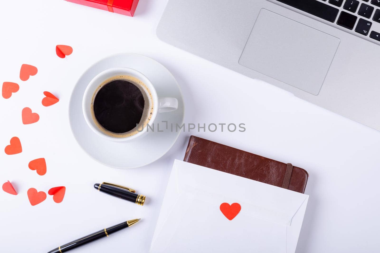 Overhead view of black coffee with love letter, fountain pen, laptop on white background, copy space. valentine's day, drink and love concept.