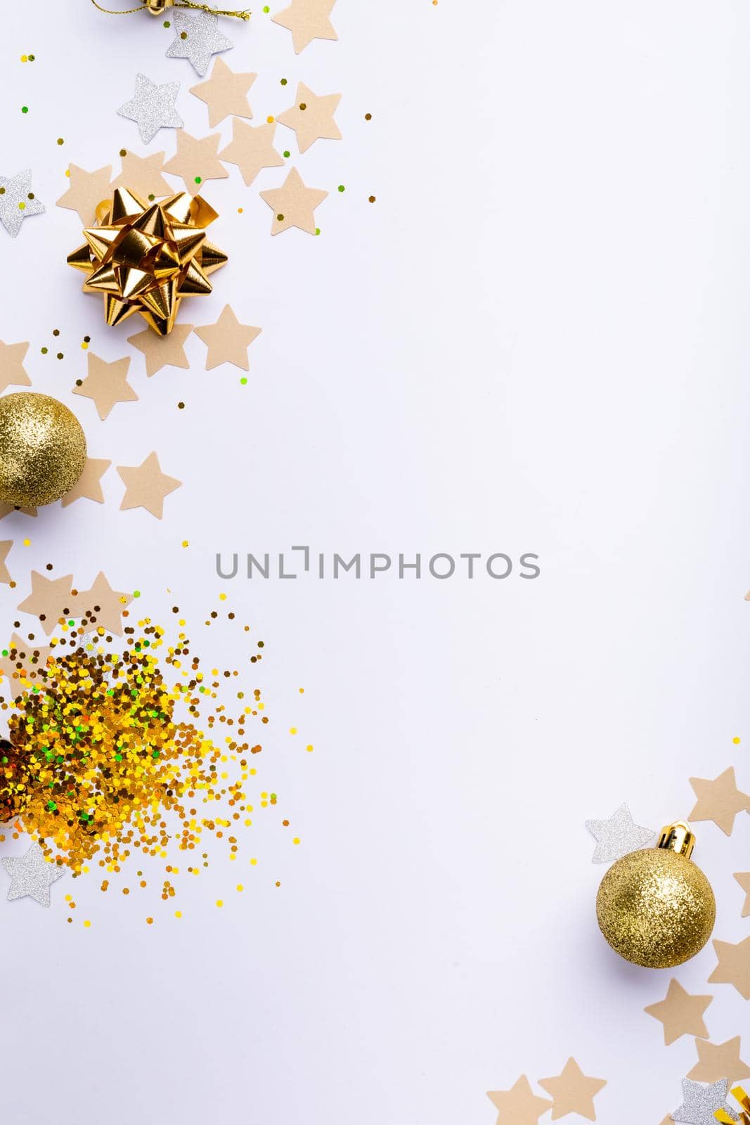 Overhead shot of gold colored decoration over white background, copy space. celebration, party and christmas concept