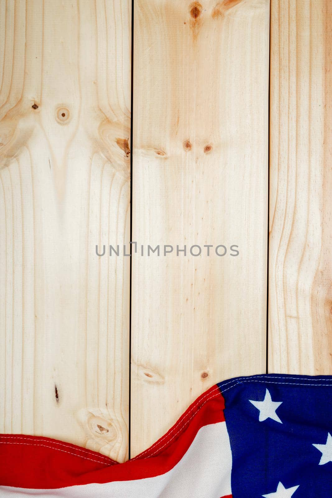 Directly above view of usa flag with stars and stripes on wooden table with copy space by Wavebreakmedia