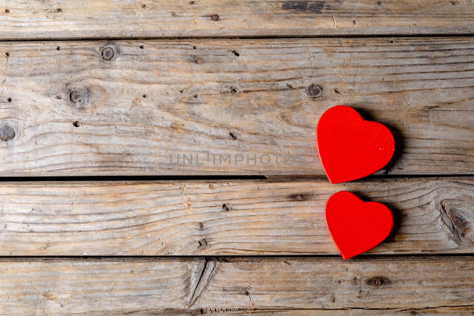 Directly above shot of red heart shaped decoration by copy space on wooden table. valentine's day and love concept.