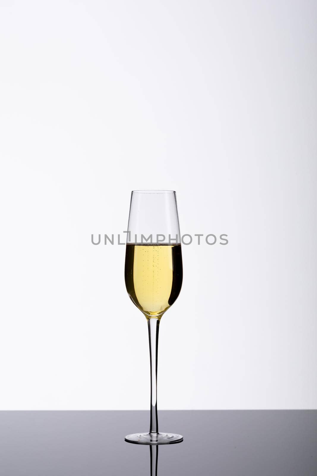 Champagne flute on table isolated over white background, copy space. drink, celebration and studio shot.