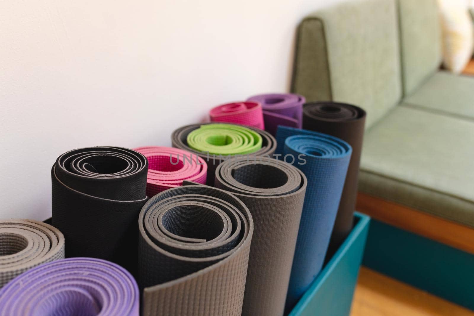 Closeup of rolled up colorful exercise mats in yoga studio. fitness, yoga and healthy lifestyle.