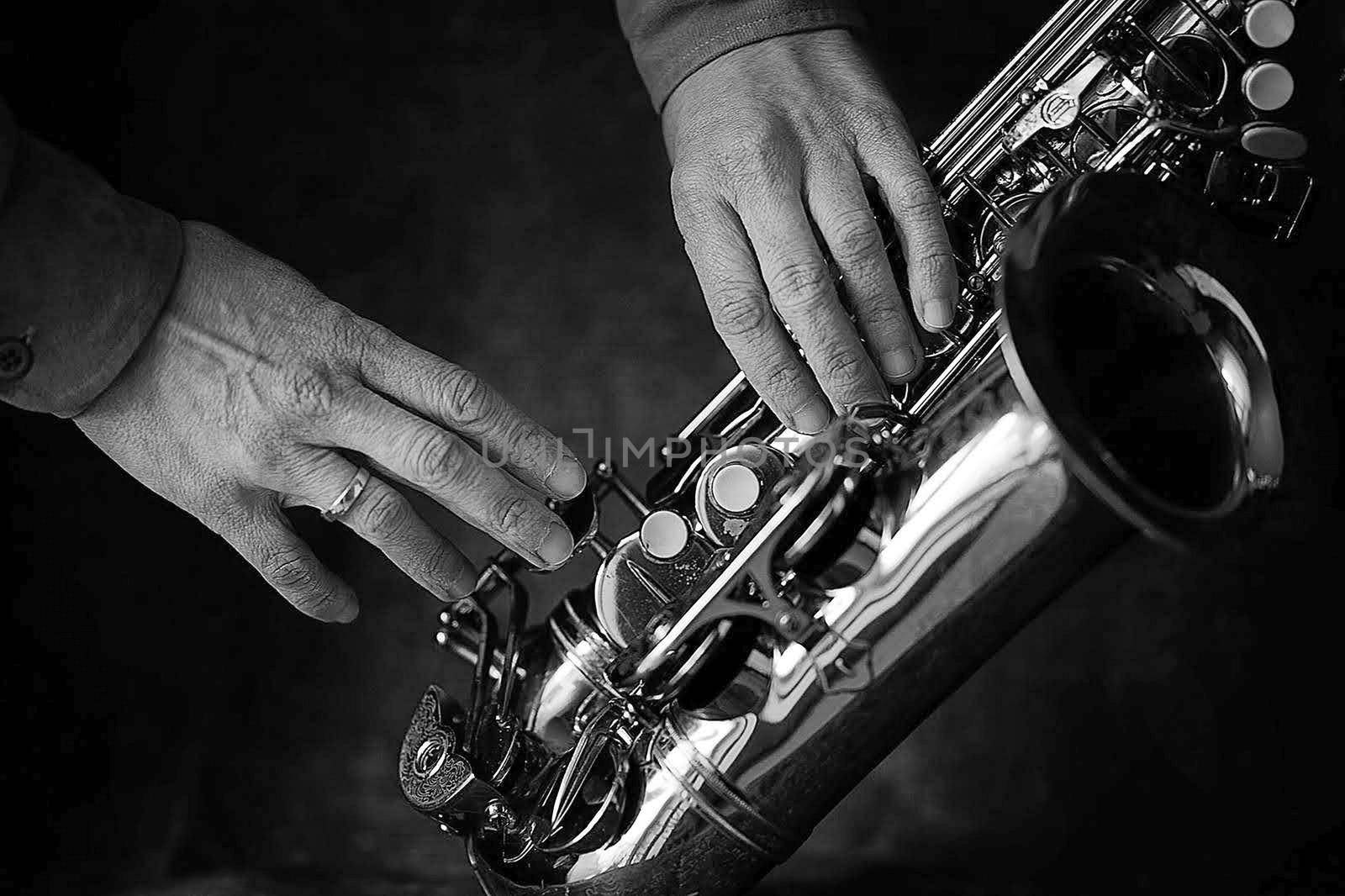 music playing the saxophone is a beautiful musical and rhythmic hobby for the soul and body for children and adults, men and women, boys and girls in the photo, the musician strokes the saxophone. High quality photo
