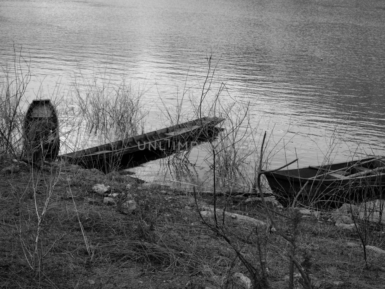 Two old wooden boats moored on the banks of the river. vintage tone