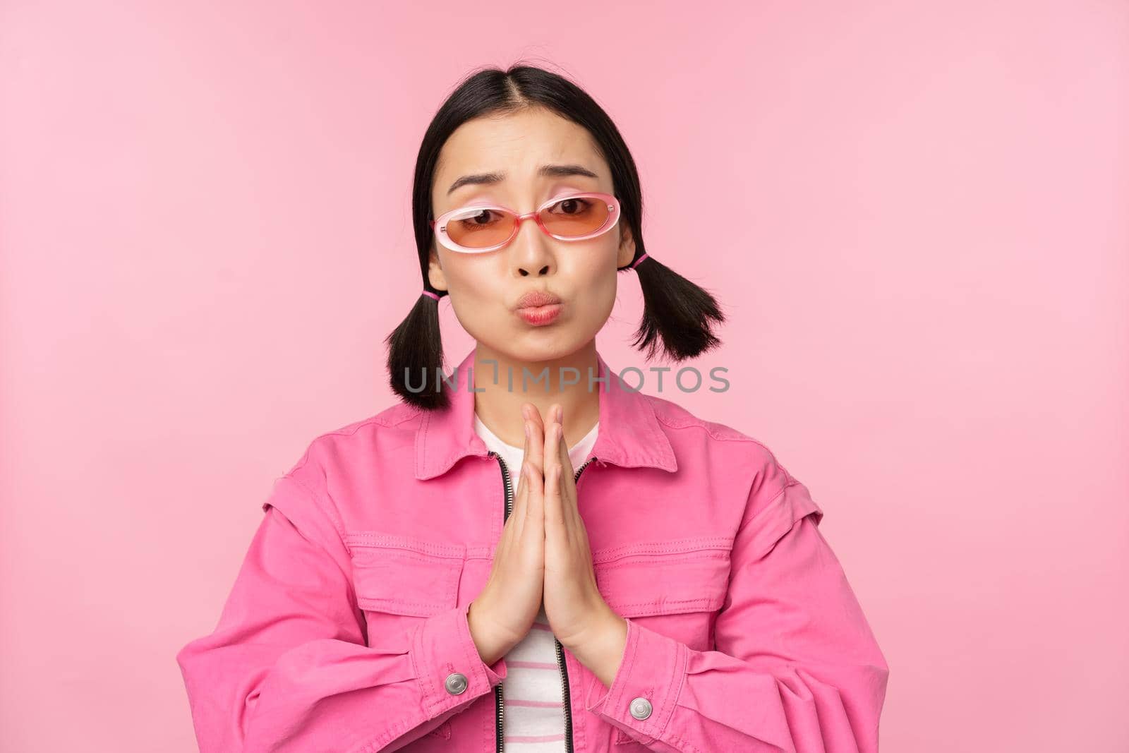 Please. Cute asian girl asking favour, begging, standing against studio background by Benzoix