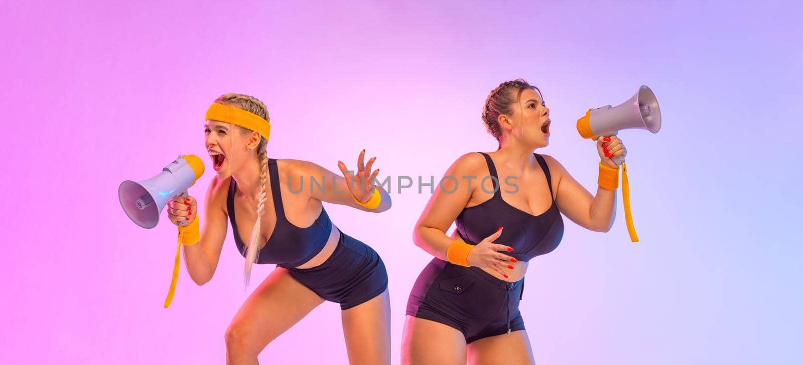 Two Emotional Women in Sportswear Screaming Using Megaphone. Social issues, protest concept. A girls speaks into a speaker about an upcoming promotion and discounts in fitness store by MikeOrlov
