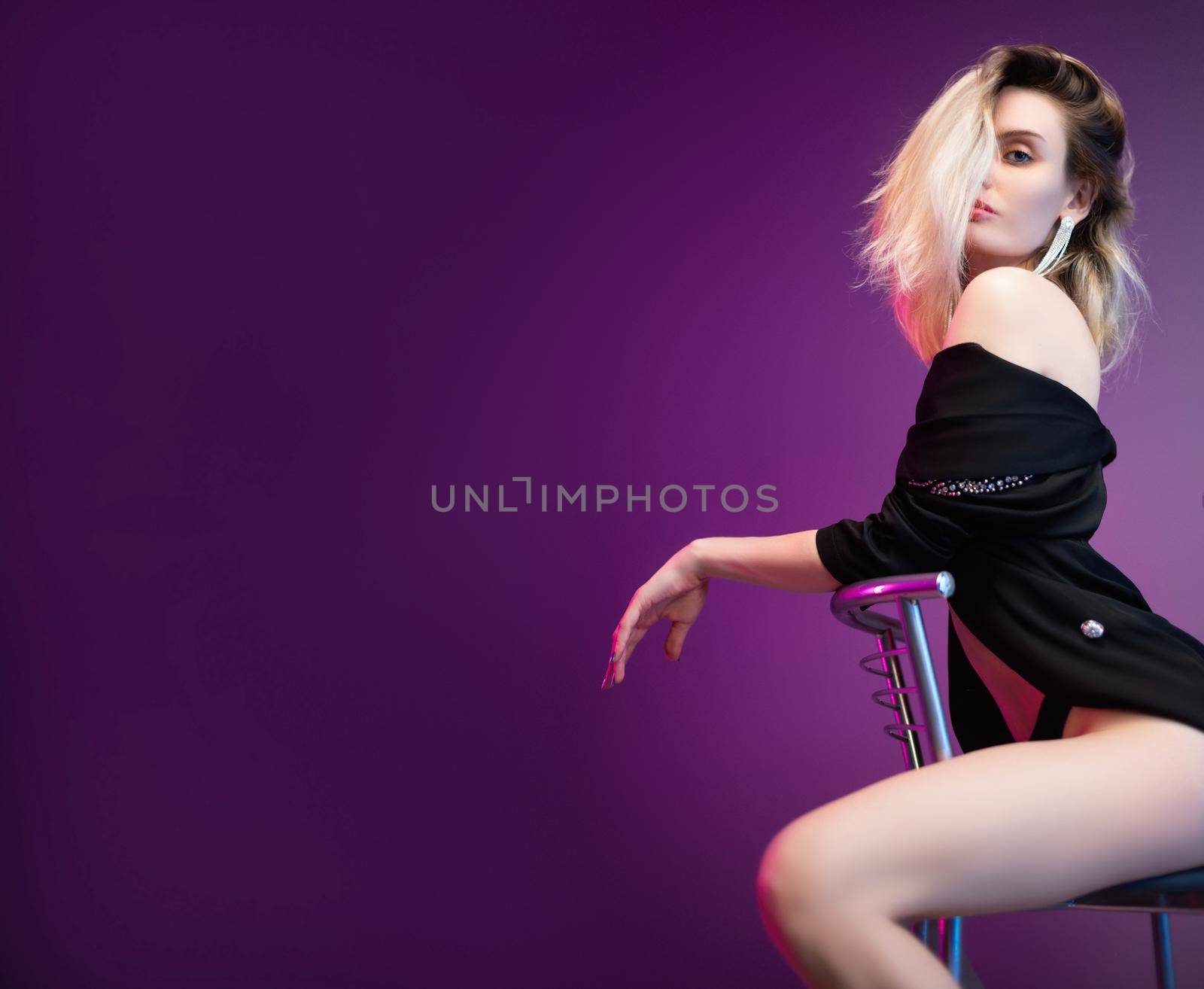 sexy half-naked girl on a bar stool, photo in the studio on a bright purple background with a place for text by Rotozey