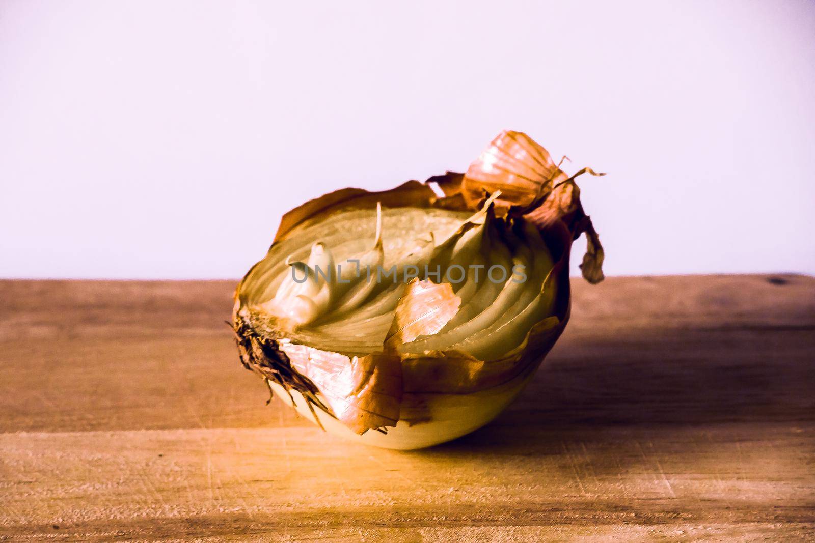 Onion halves on a piece of wood, Onion rot, Onion grows.