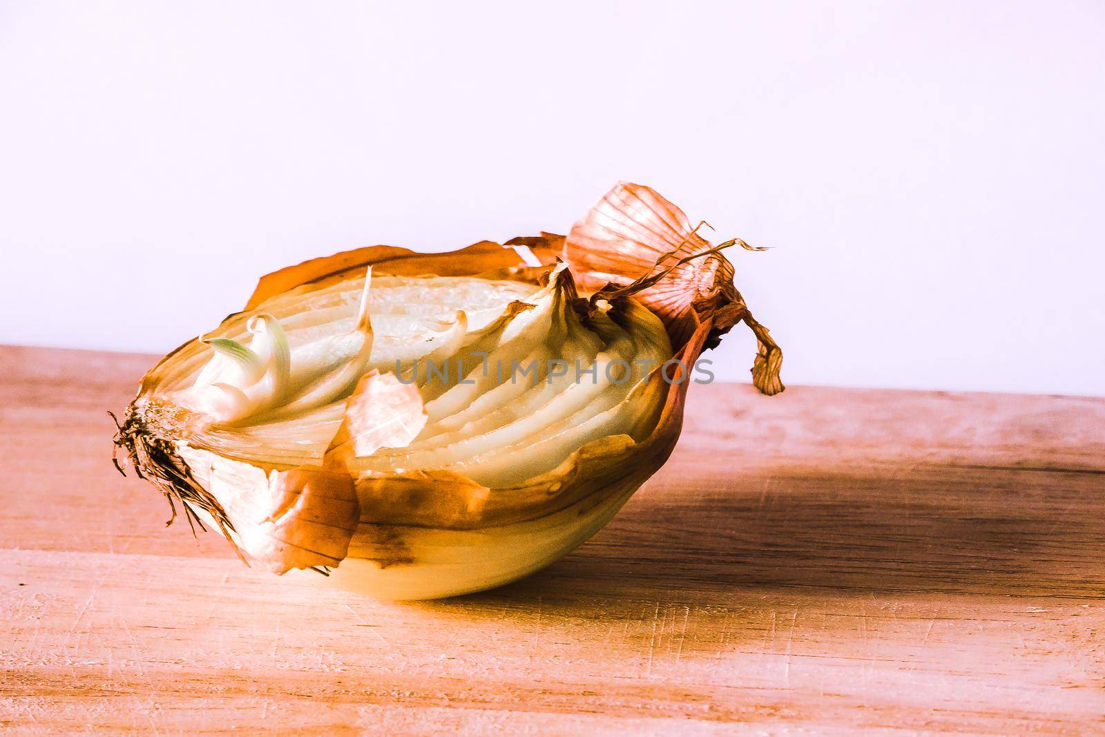 Onion halves on a piece of wood, Onion rot, Onion grows.