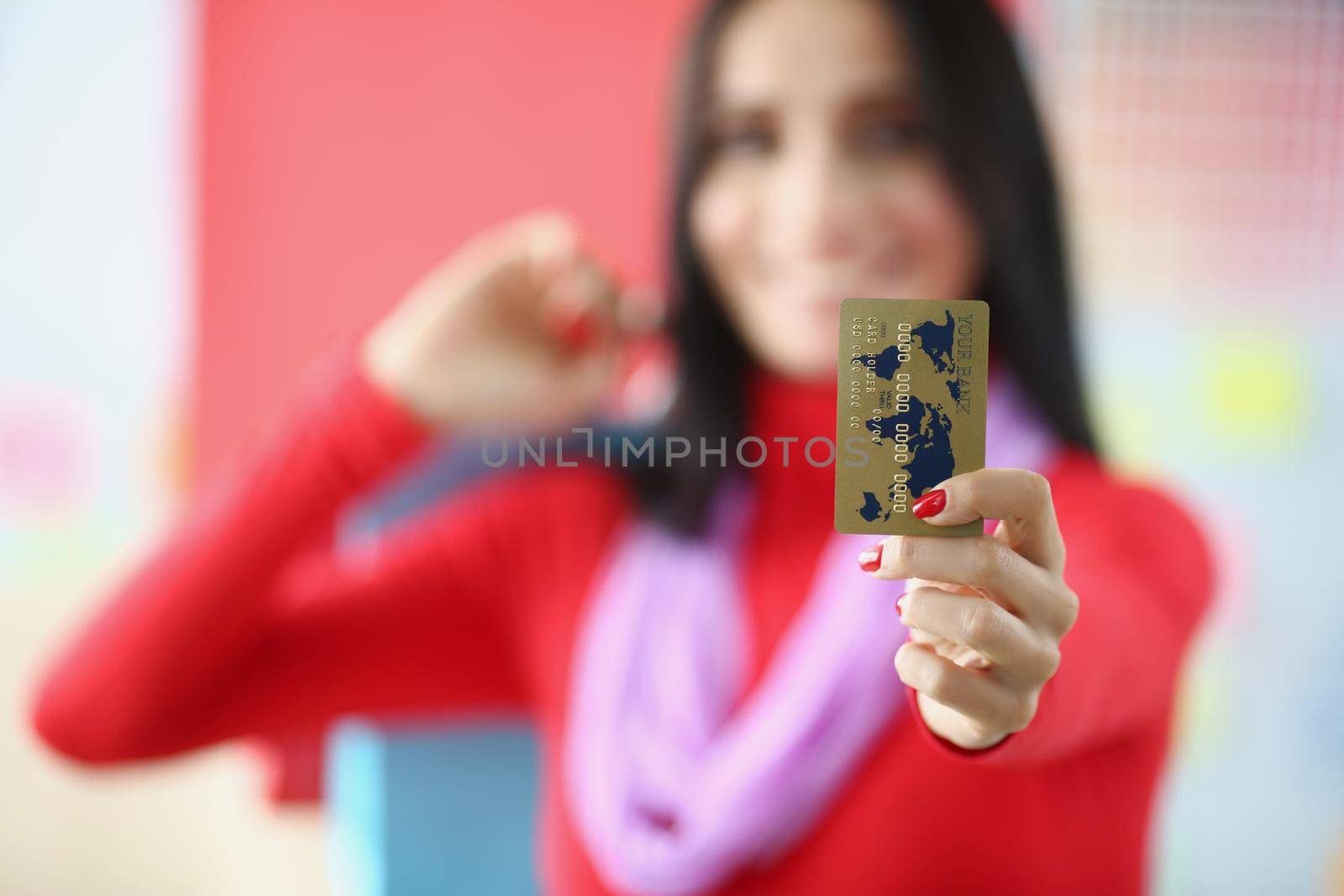 Close-up of woman show gold credit card, modern way to make transaction online. Online shopping, development, contactless payment, finance, banking concept