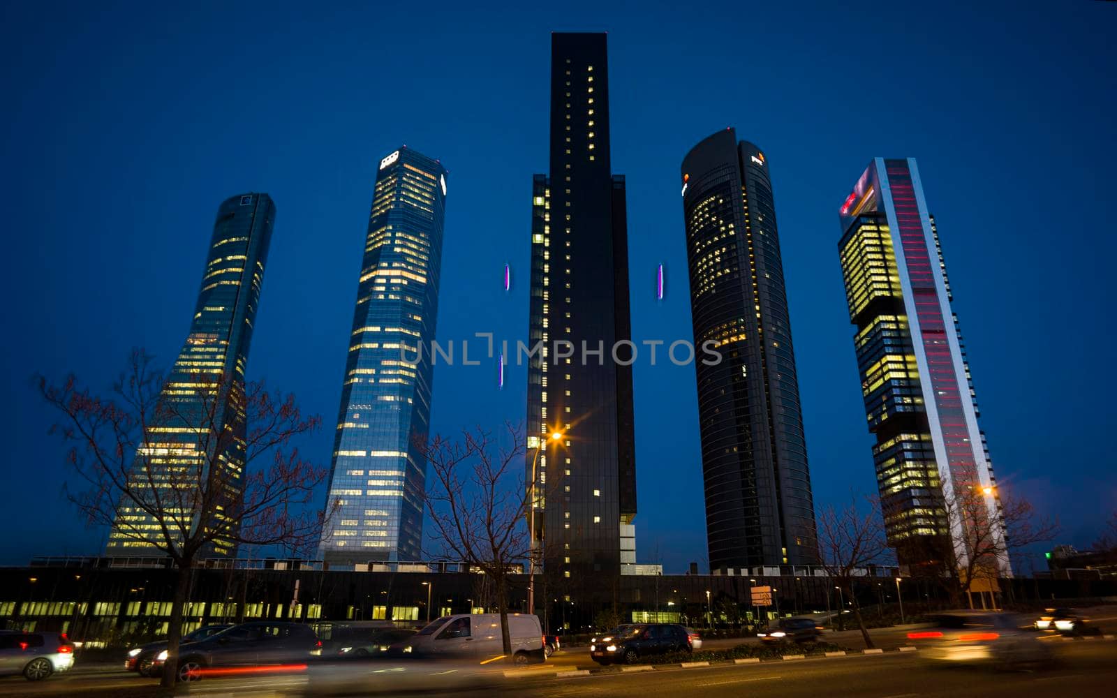 Night view of the Cuatro Torres Business Area, Madrid's main financial area. The glass tower is the tallest in Spain, at 249 meters.