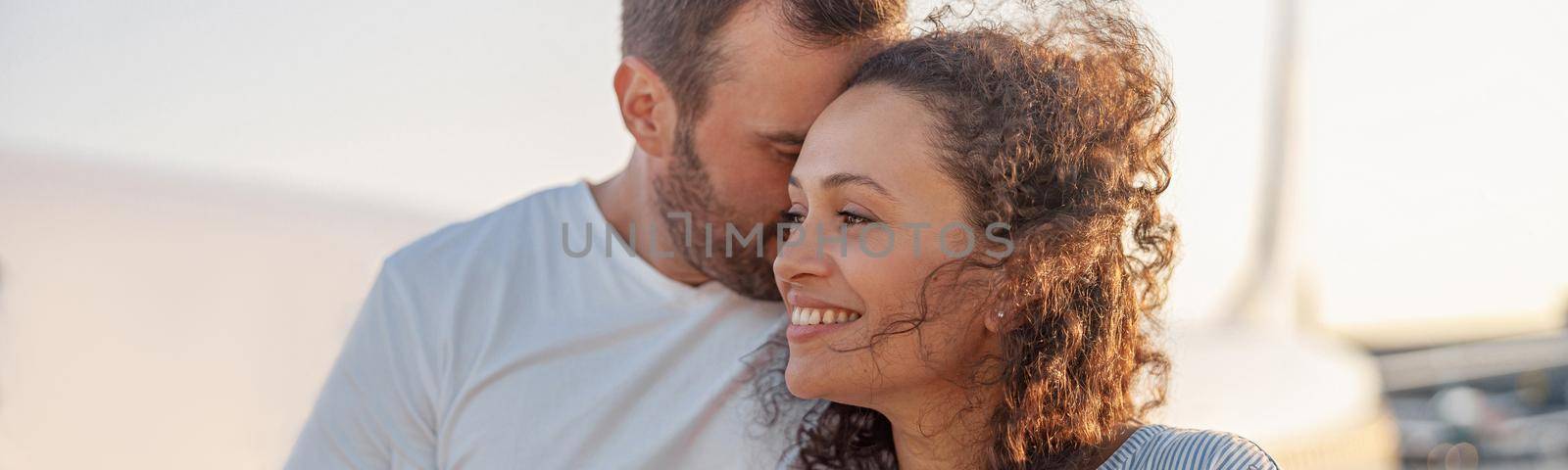 Portrait of lovely couple of tourists, man and woman looking happy while standing outdoors ready for boarding the plane at sunset by Yaroslav_astakhov