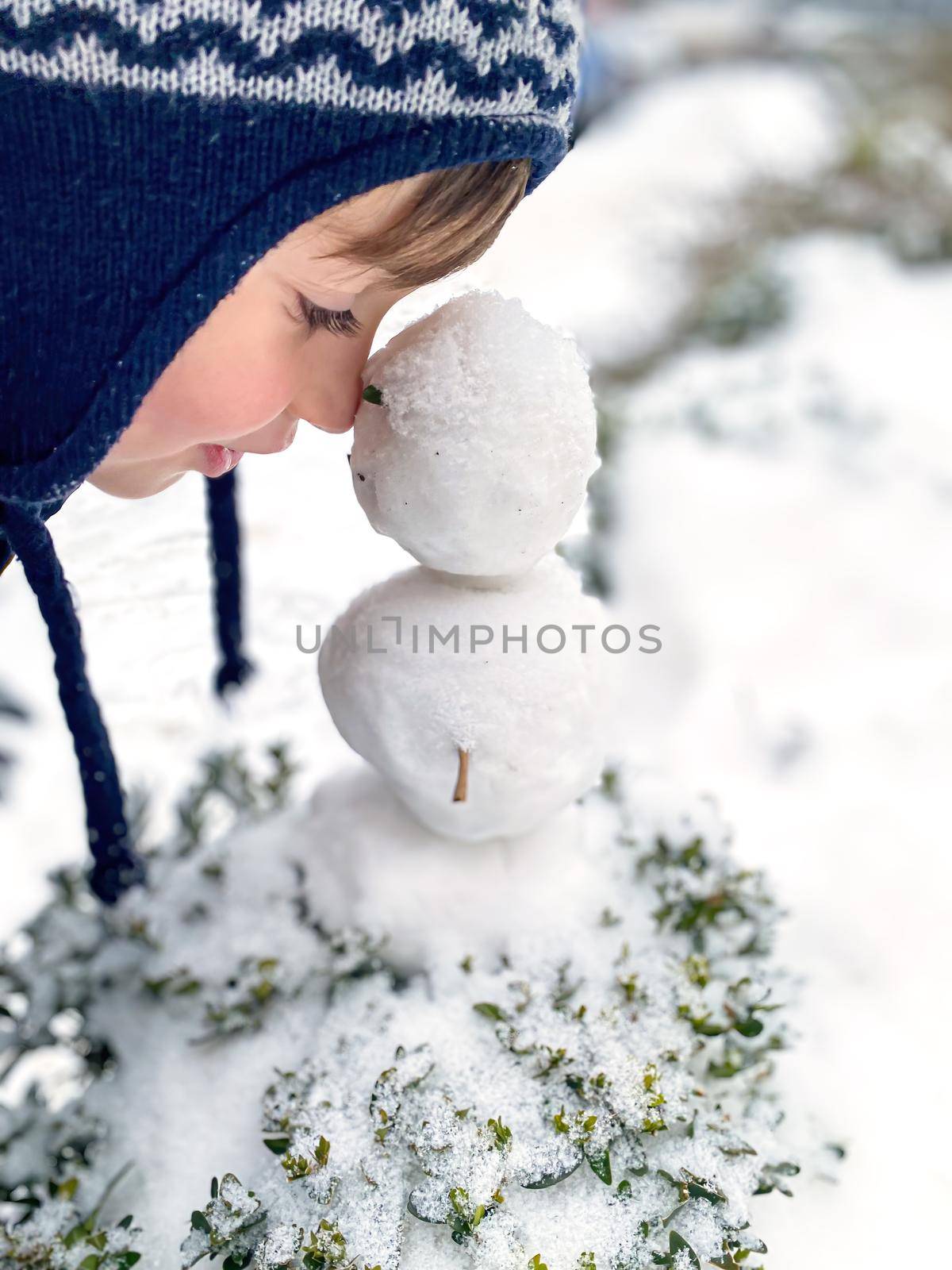happy five year old boy in the snow in winter by palinchak
