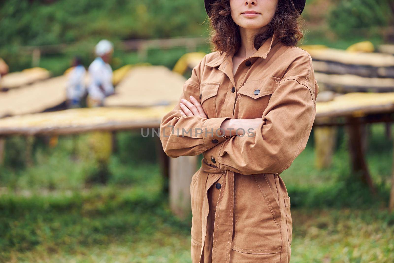 caucasian woman is standing in front of coffee washing station in eastern africa region