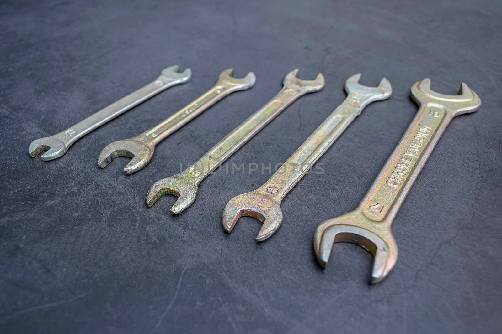 Set of new wrenches made of chromium and vanadium alloy on a dark surface