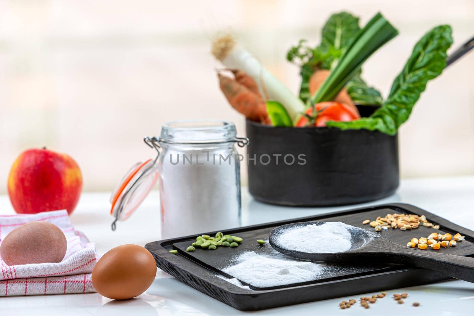 Bicarbonate surrounded by fruits and vegetables on a white background, view from above