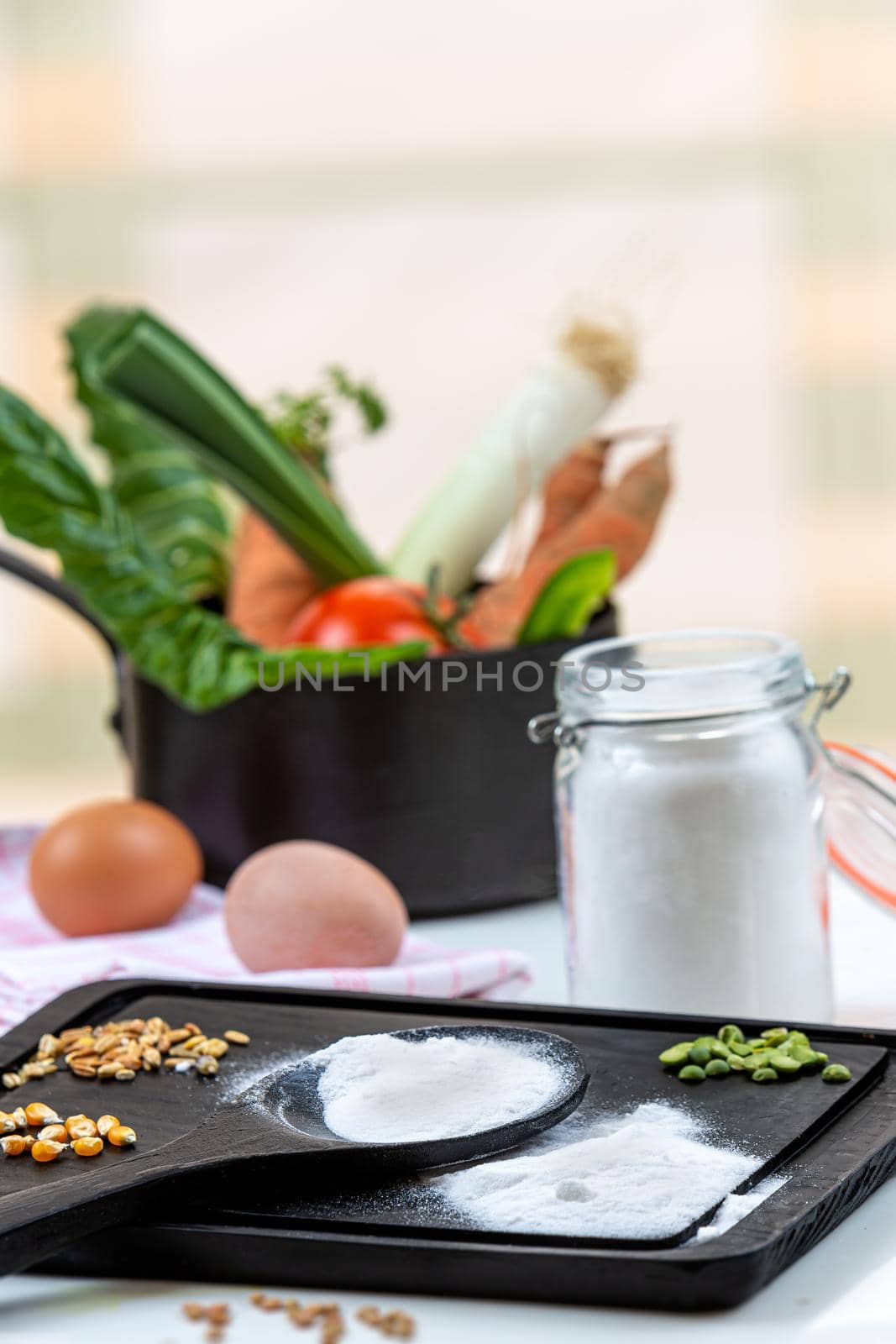 Bicarbonate surrounded by fruits and vegetables on a white background, view from above