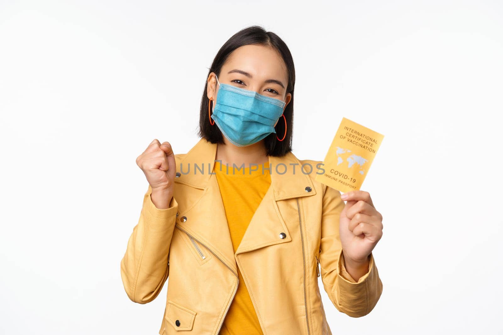 Hey you got point. Cheerful cute asian lively girl dark short haircut pointing camera finger-pistol smiling broadly, encourage friend make move, congratulate coworker good job, stand blue background.