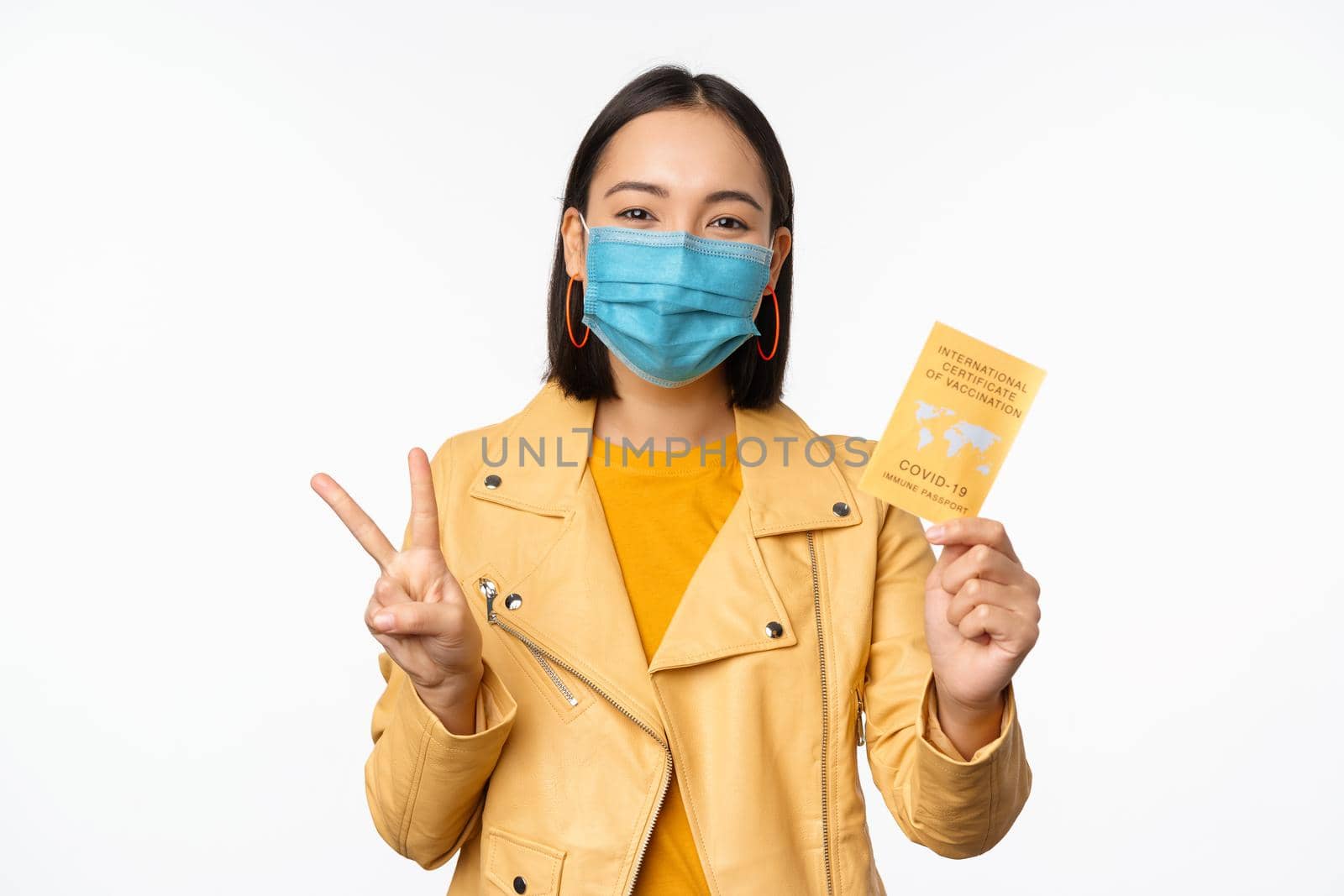 Hey you got point. Cheerful cute asian lively girl dark short haircut pointing camera finger-pistol smiling broadly, encourage friend make move, congratulate coworker good job, stand blue background by Benzoix