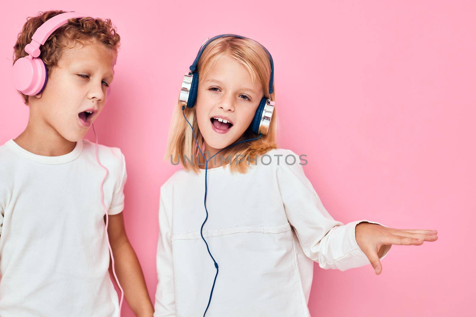 boy and girl stand next to in headphones lifestyle childhood. High quality photo