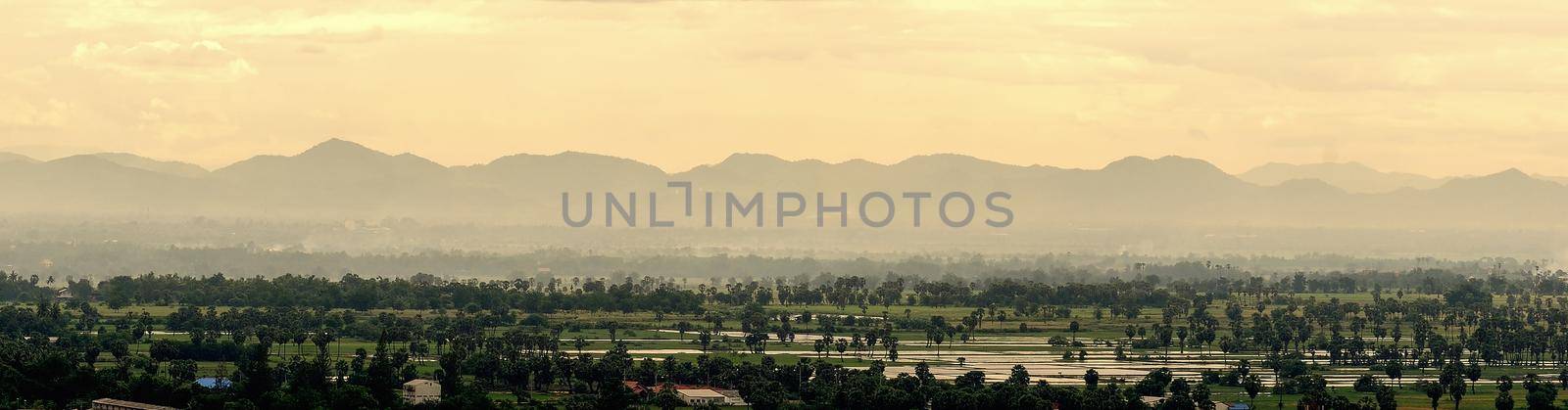 City and countryside scape with blue sky, clouds and green grass in the summer day