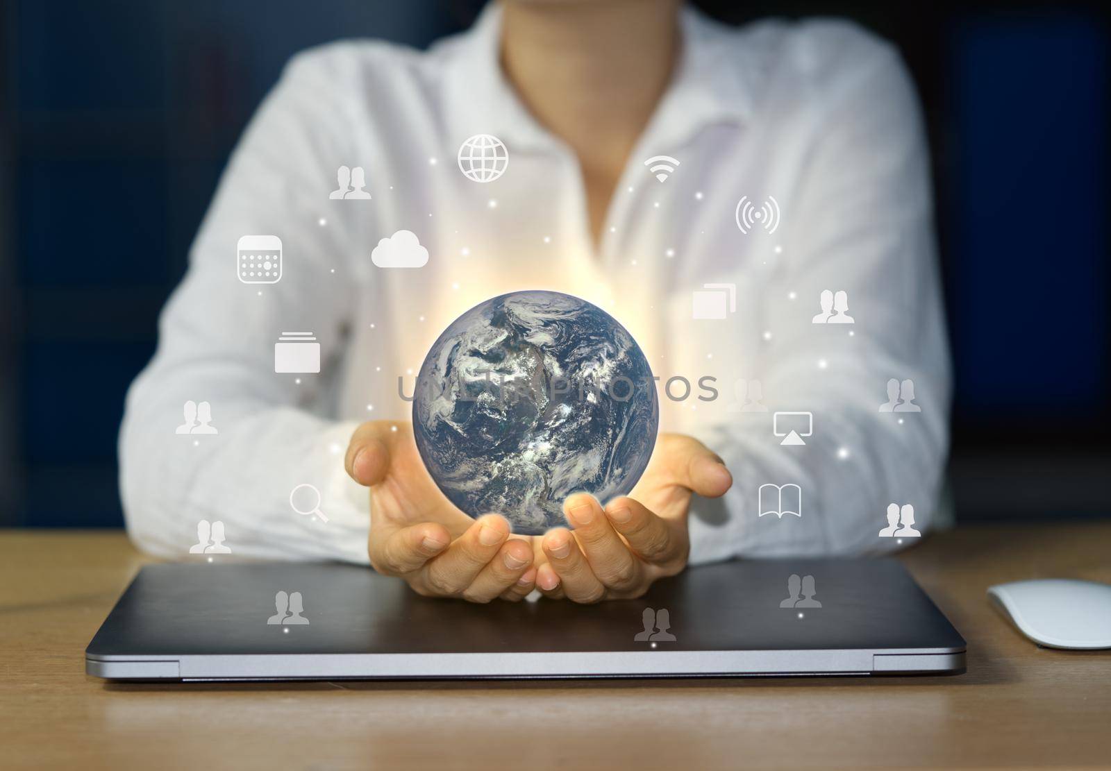 Business people hold the concept world of using the internet to exchange knowledge, cloud storage, and distribute information around the world using laptops. Elements of this image furnished by NASA.