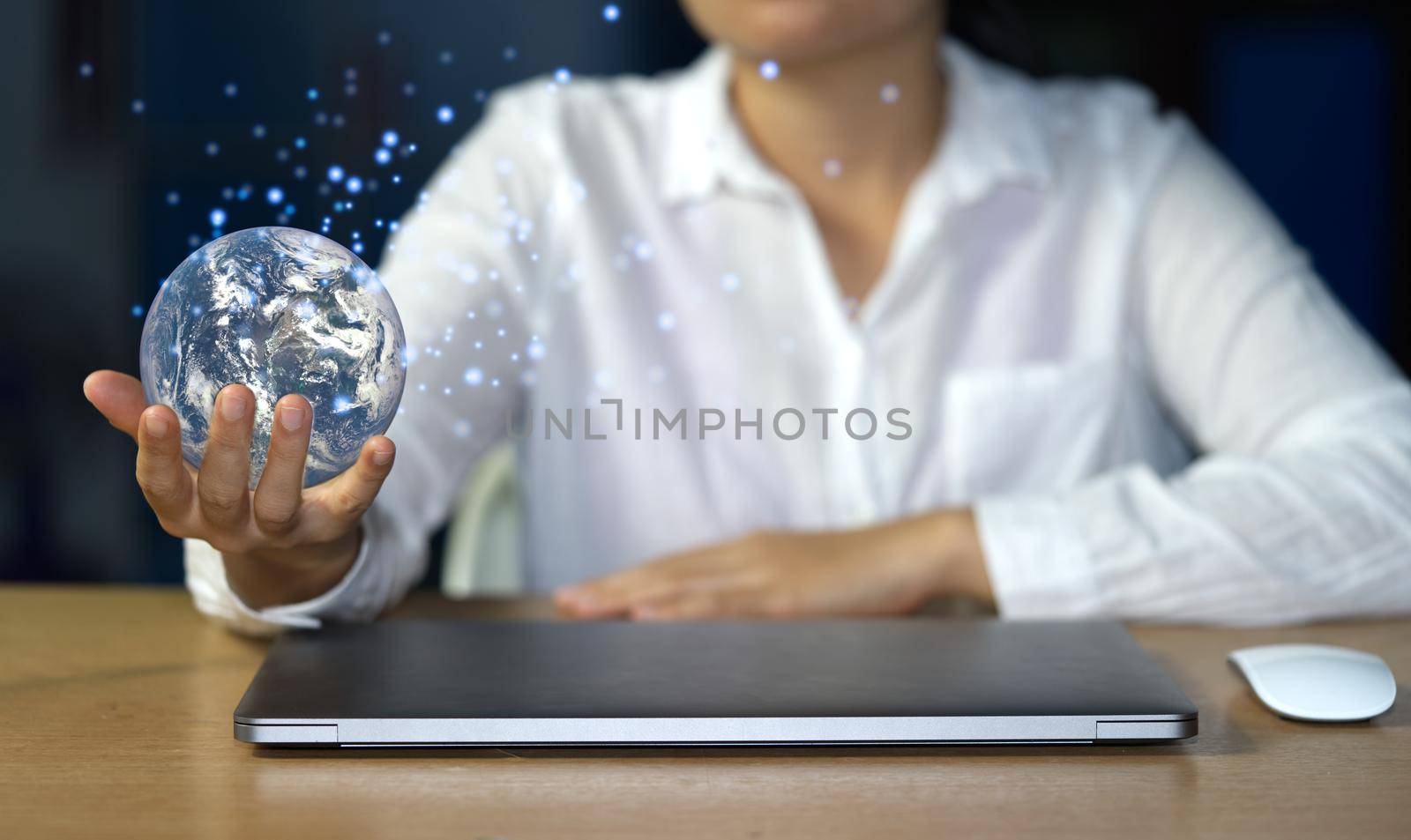Businessman holds the concept world of internet network to exchange and disseminate information rapidly around the world using a laptop to surf the web. Elements of this image furnished by NASA.