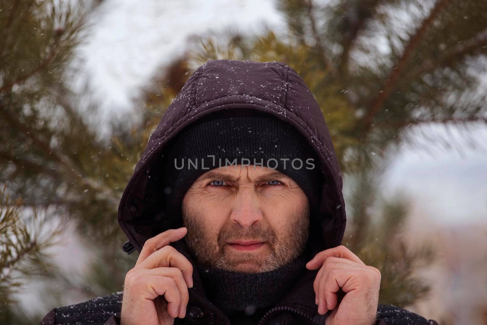 Portrait of a handsome strict man holding a hood with his hands. by gelog67