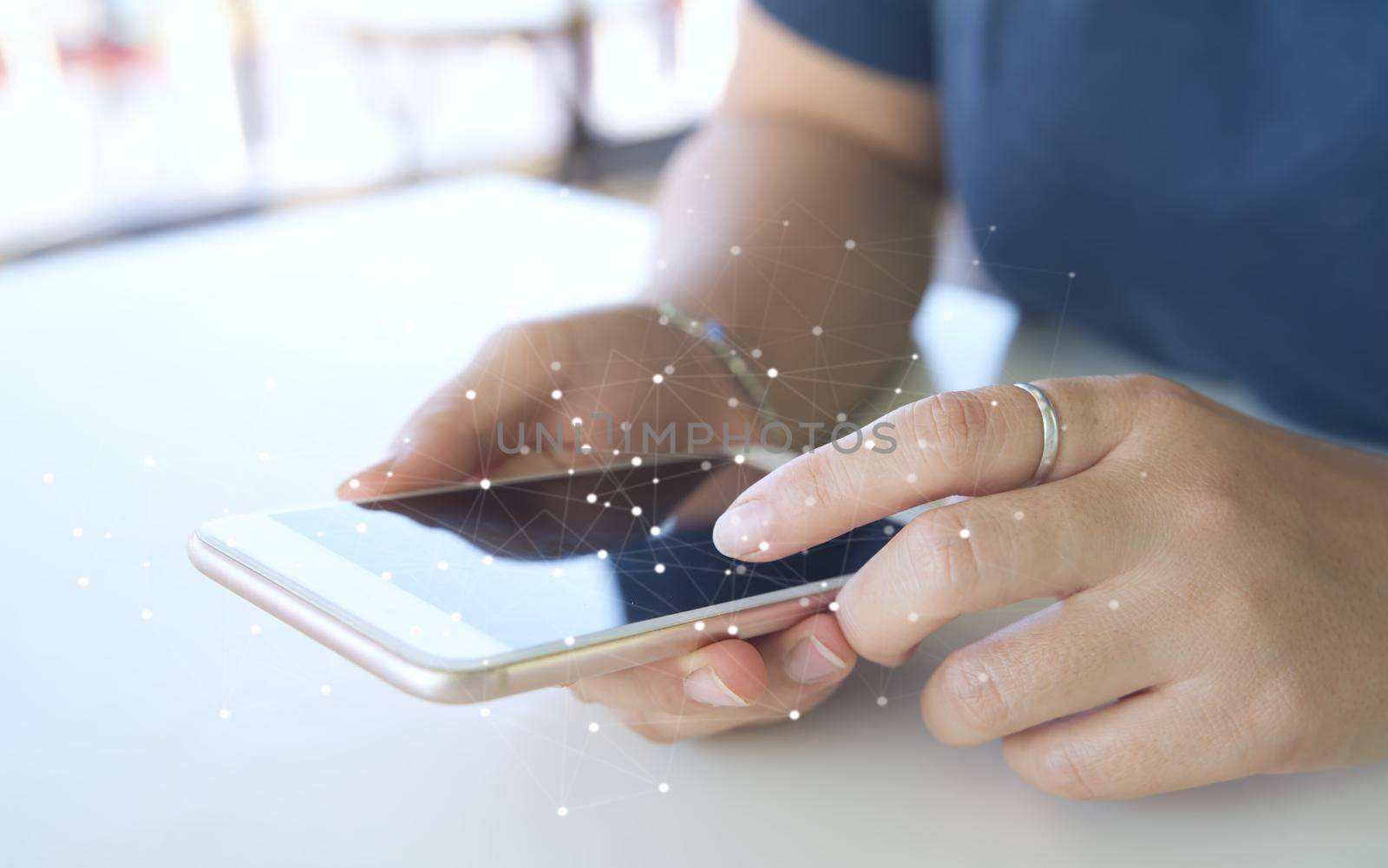 A woman uses a touchscreen smartphone to communicate. Connect the information in the online world at a coffee shop according to the lifestyle of urban people.