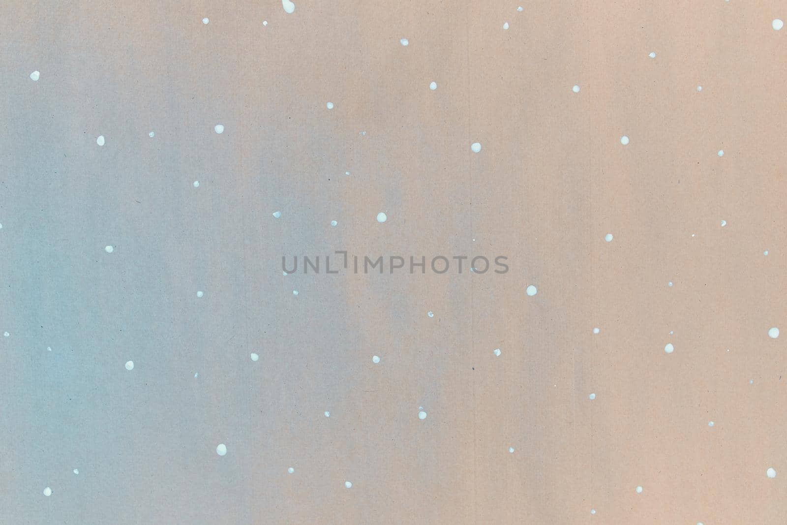 Texture of gift wrapping paper. Abstract drawing on craft paper for surprises. White dots in the form of snowflakes. The concept of Christmas and the New year.