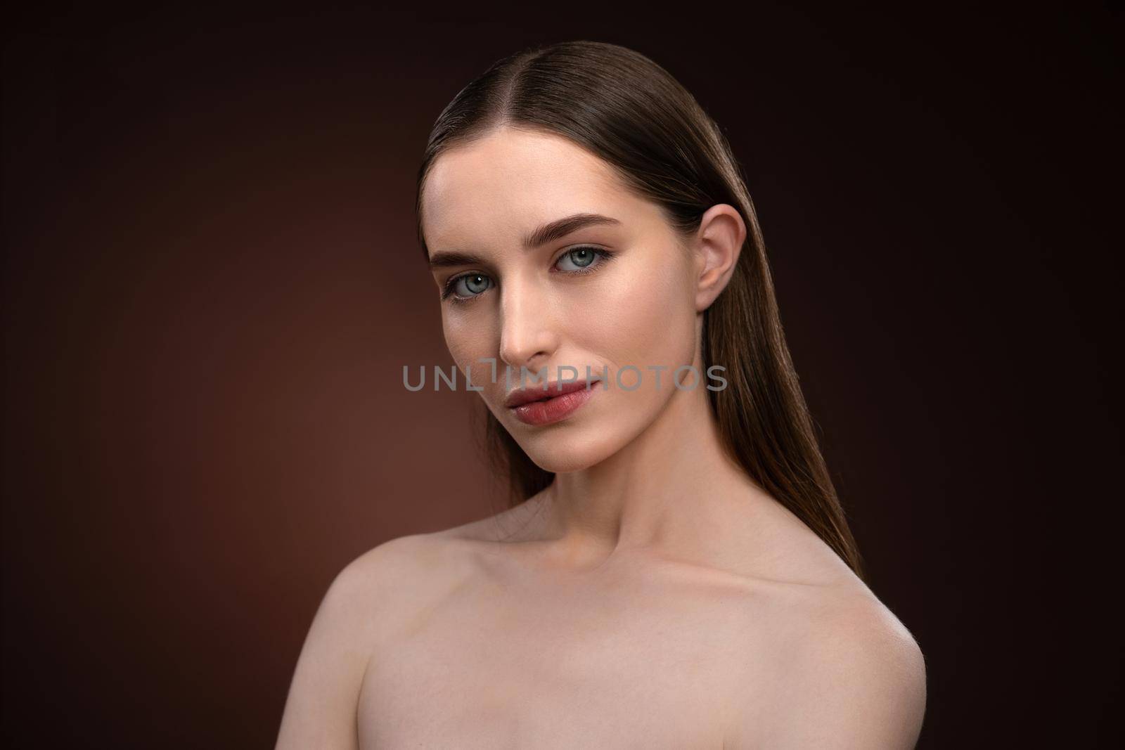 Standing half-turned natural beauty woman with no make up face portrait. Healthy pure skin model posing on camera isolated on black background. Natural make up concept. Spa and beautiful concept.