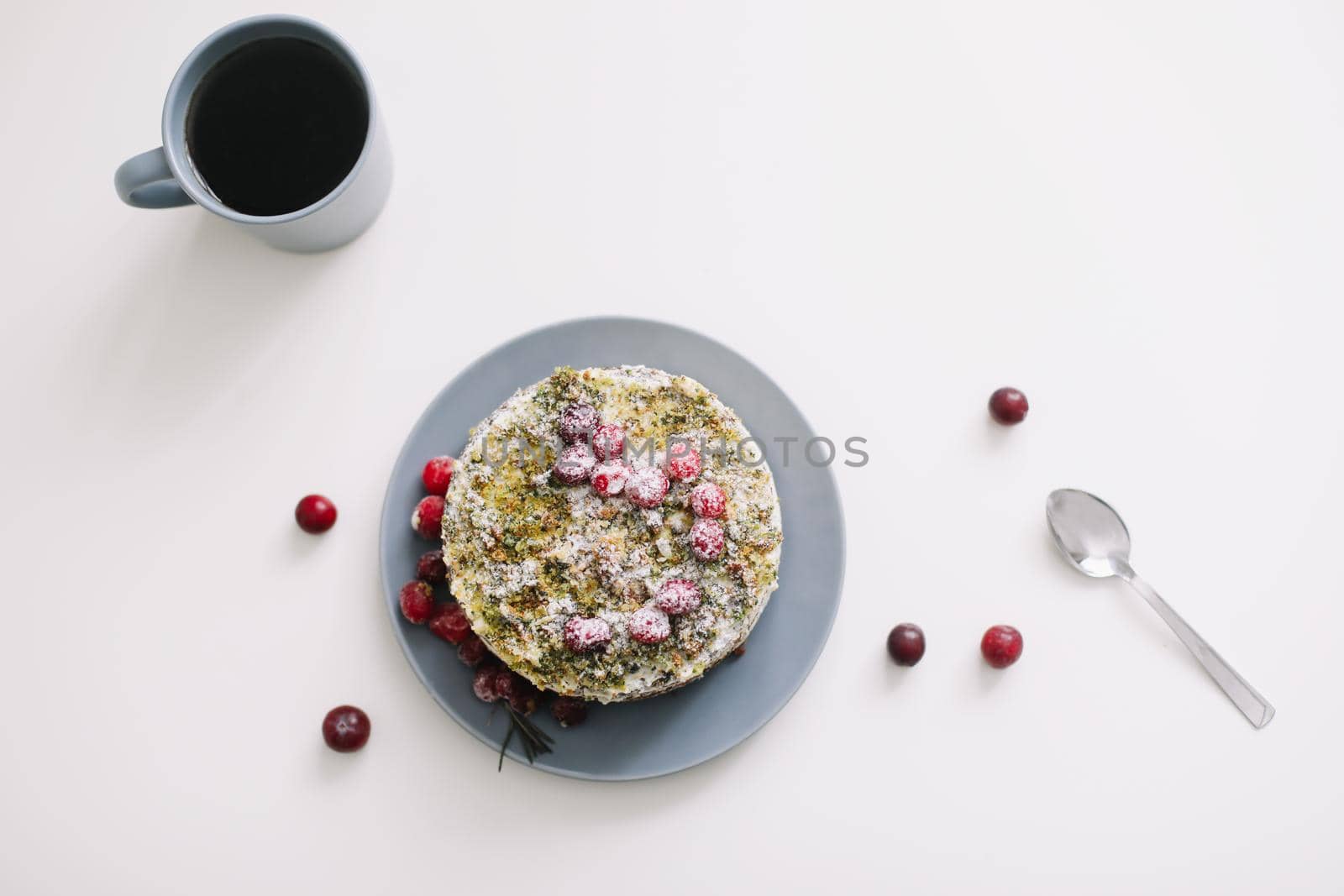 homemade cake with spinach and cream decorated with fresh cranberries on white table, diet breakfast by paralisart