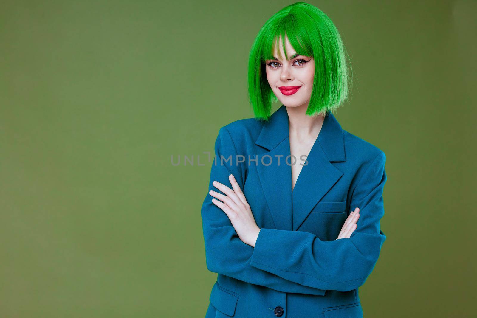 Beautiful fashionable girl Glamor green wig red lips blue jacket color background unaltered. High quality photo
