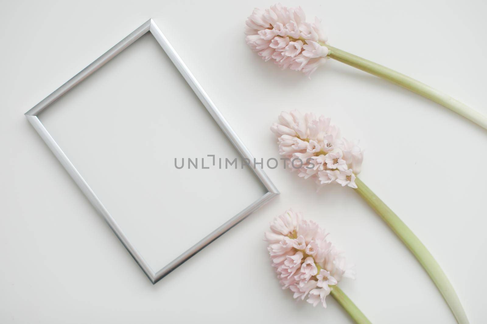 mockup with pink flowers and blank photo frame with copy space