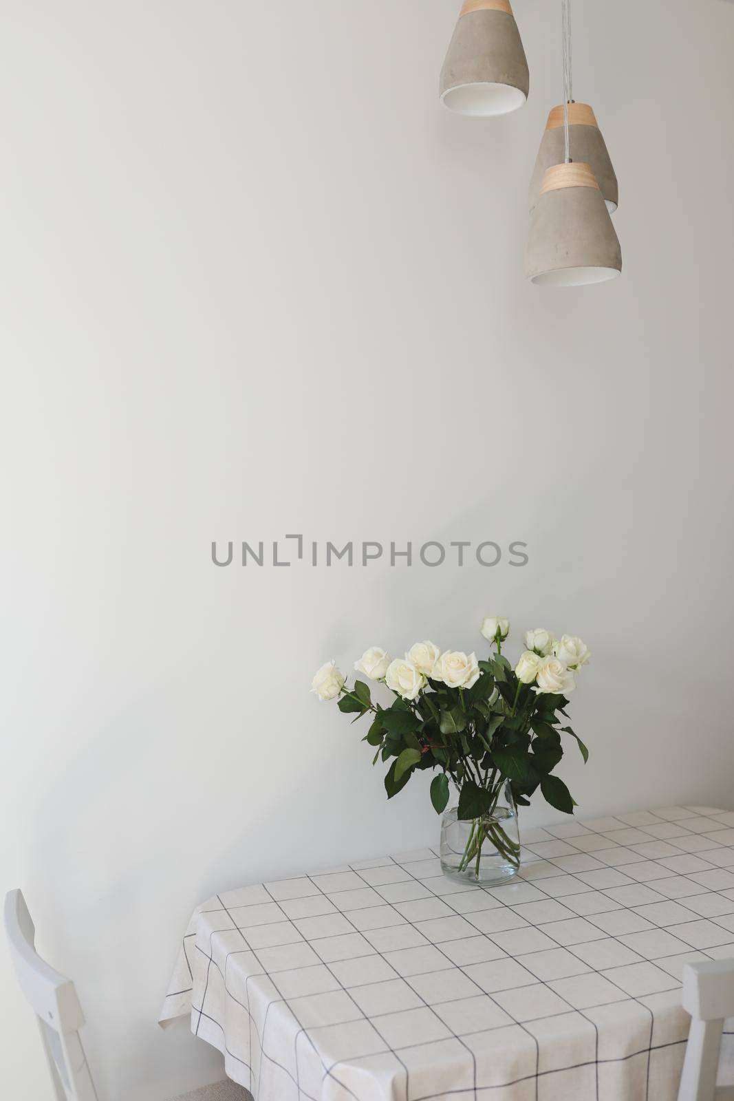 White rose bouquet in a cozy home interior. Floral spring background by paralisart